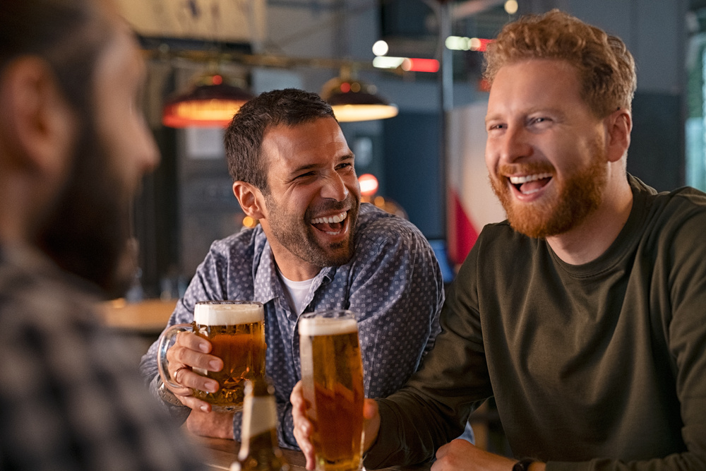 men smiling with beer