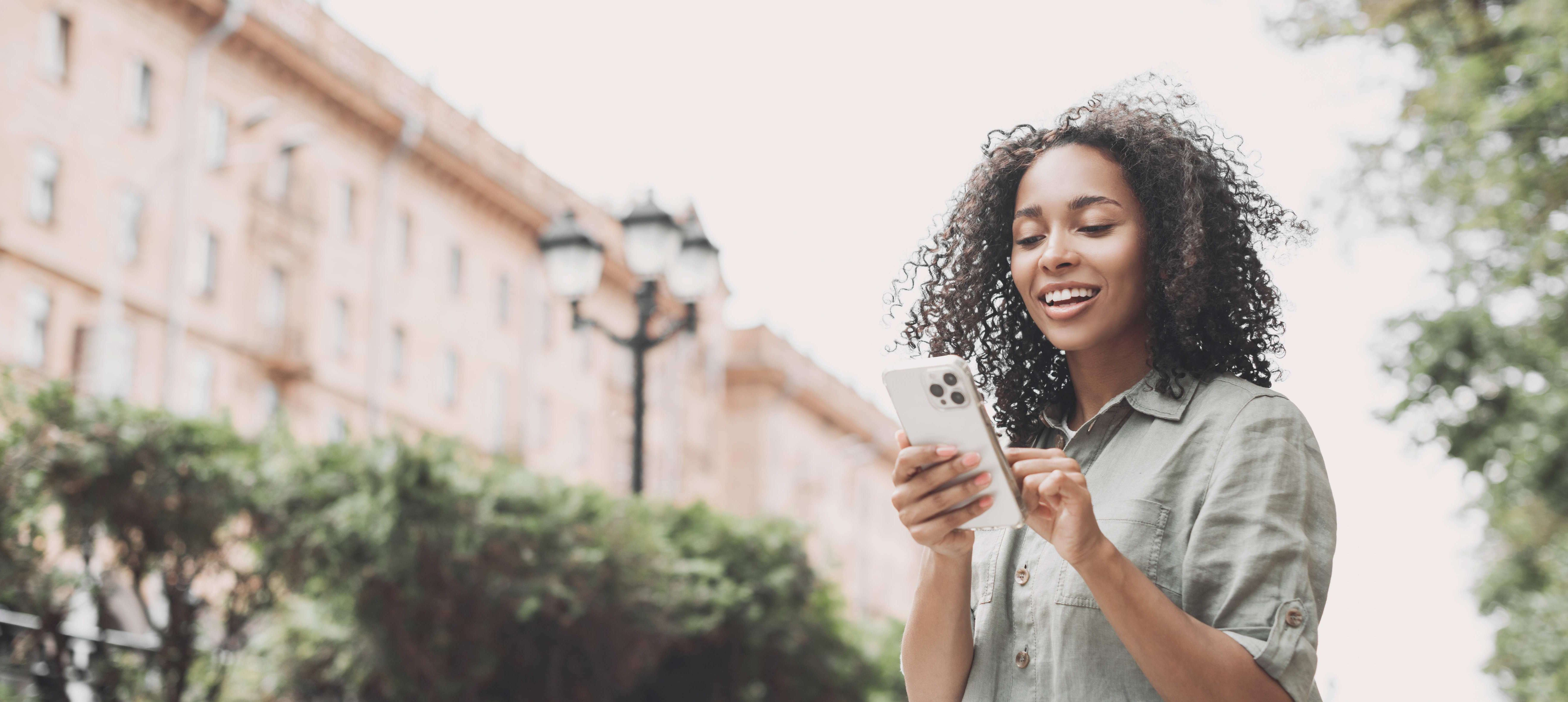 Women outside on smart phone SI