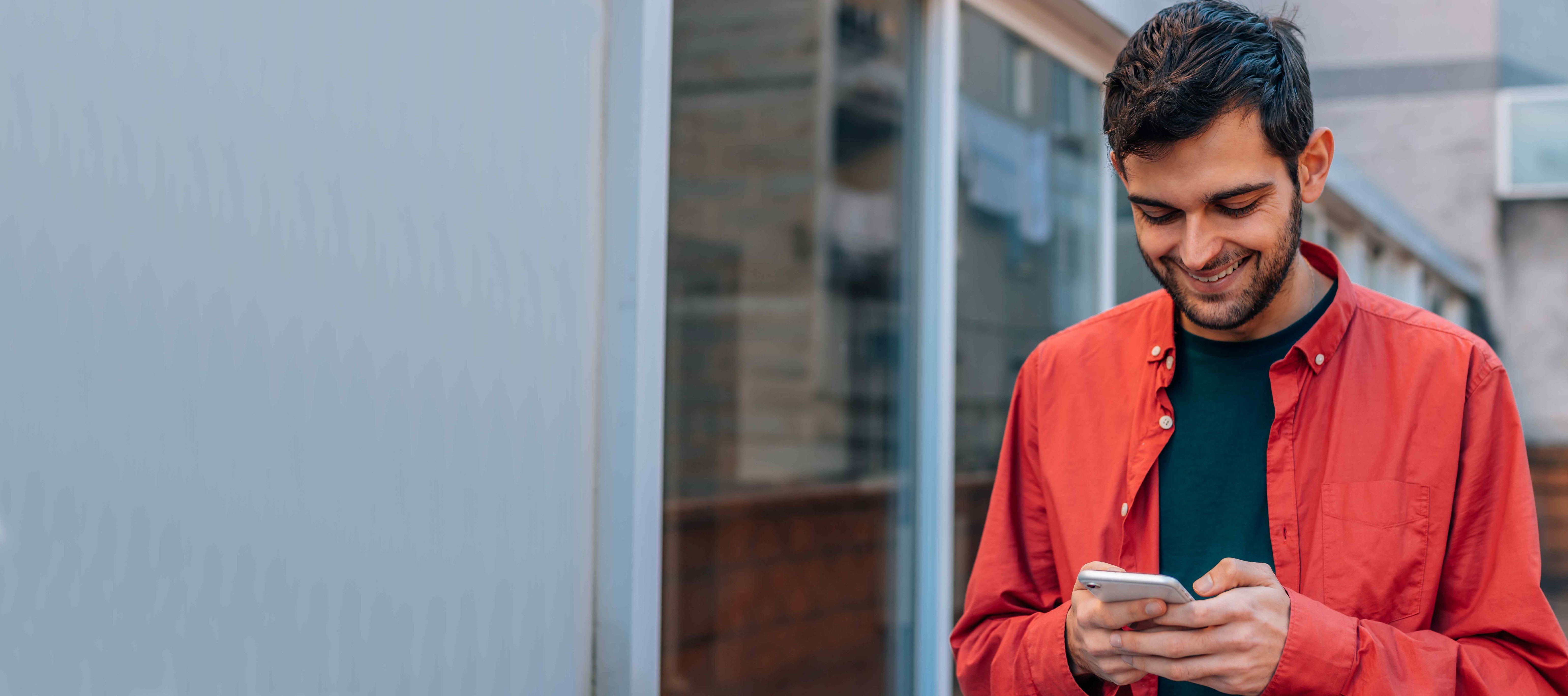 urban style man using mobile or cell phone in the street outdoors