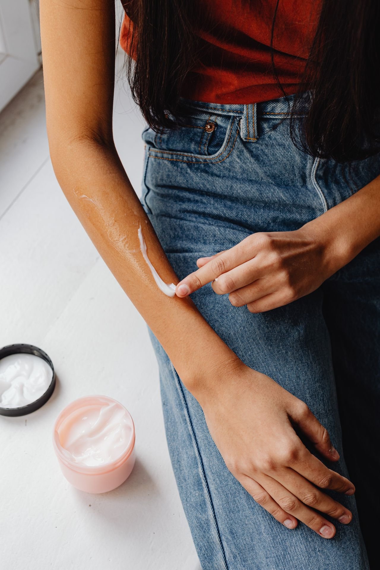 Close-up of moisturiser being applied to a dry patch of skin on the arm