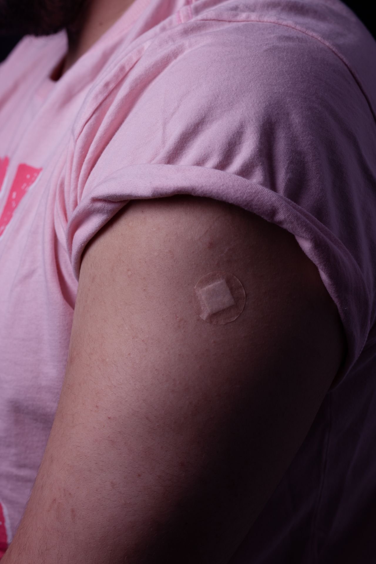 Close-up of a contraceptive patch applied to a person's upper arm