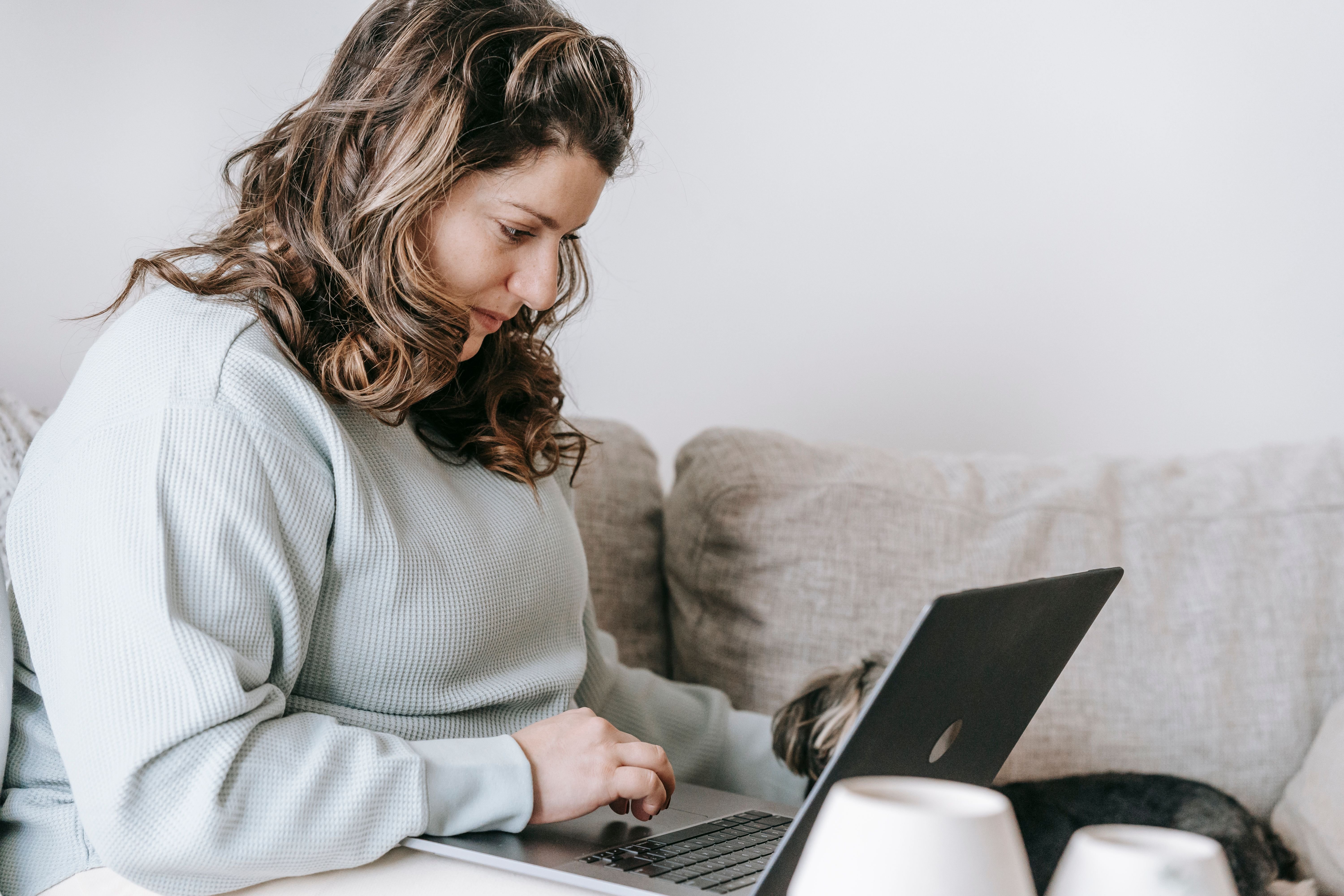 overweight woman sat on laptop