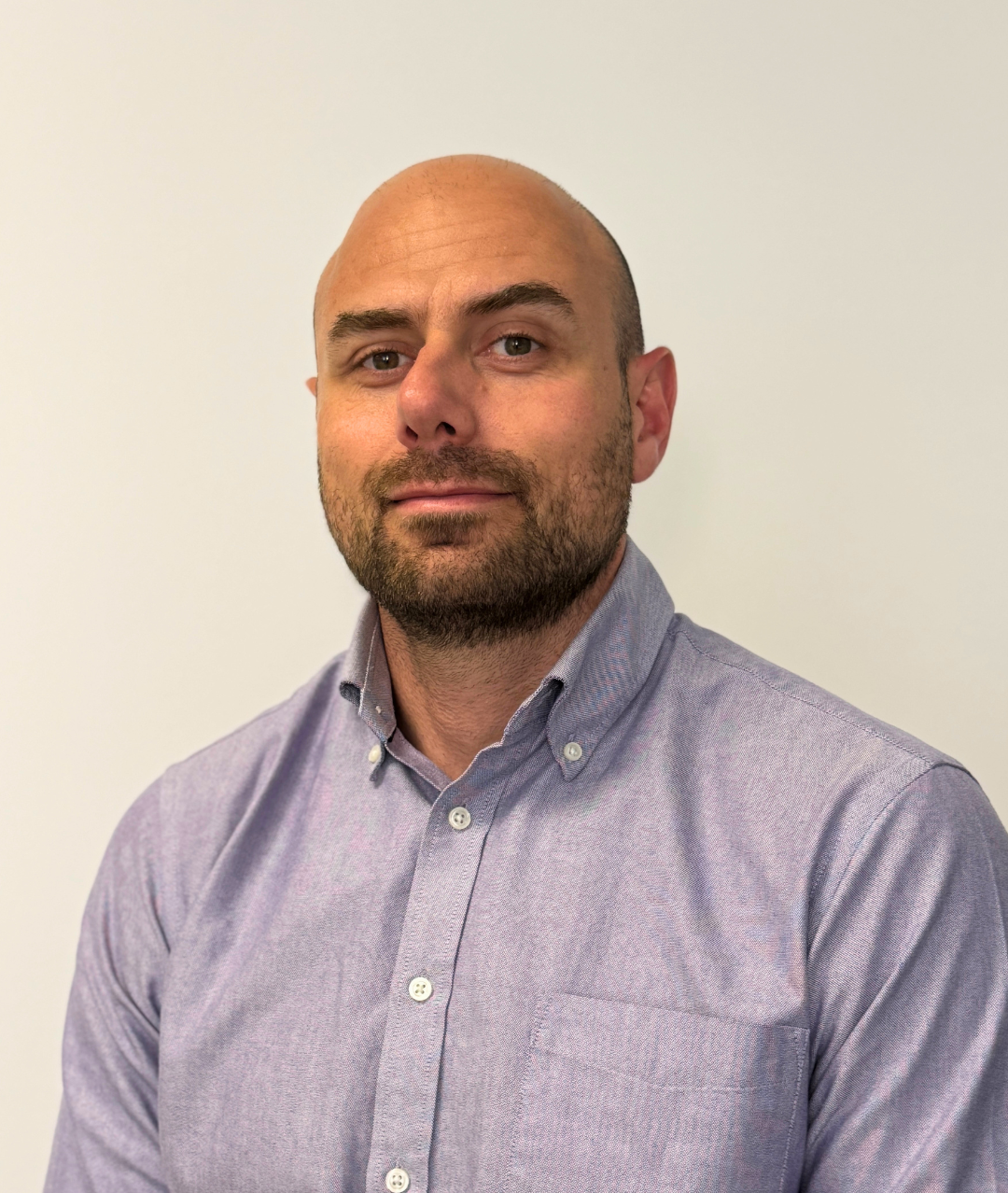 Headshot of Patrick Roberts, Clinical Director (Physiotherapy), a bald man with a beard