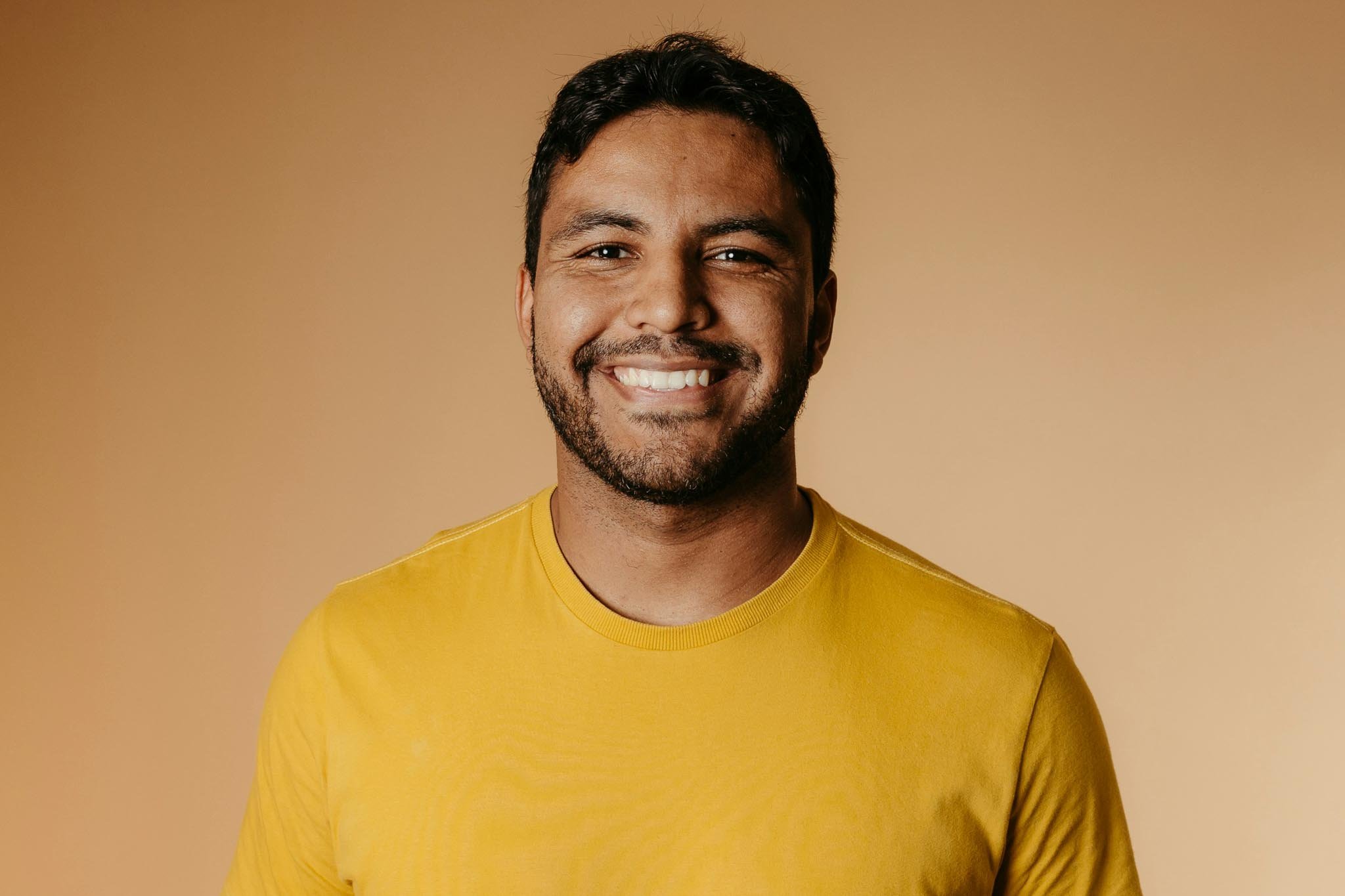 Asian man with yellow top