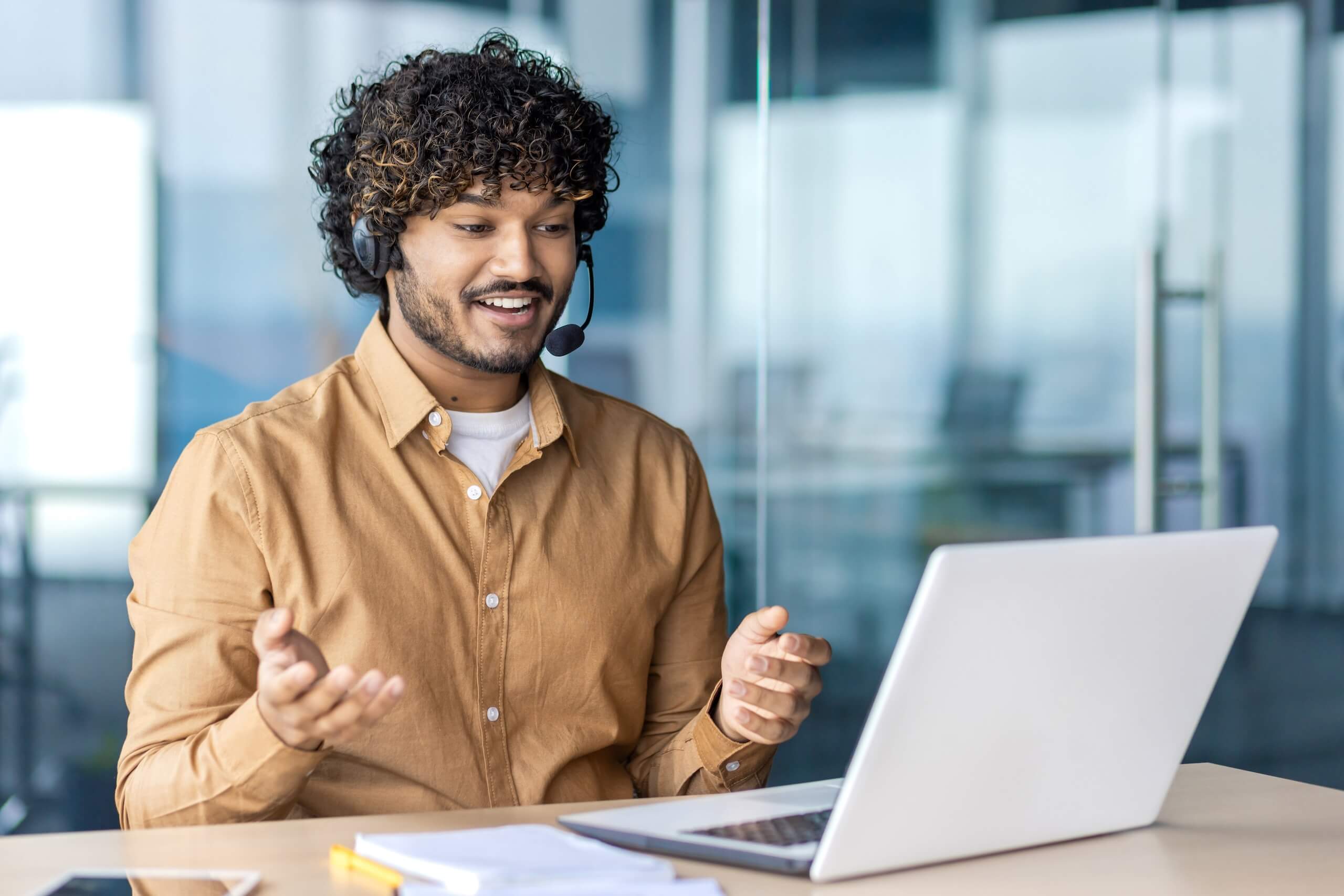 Man on laptop with a headset
