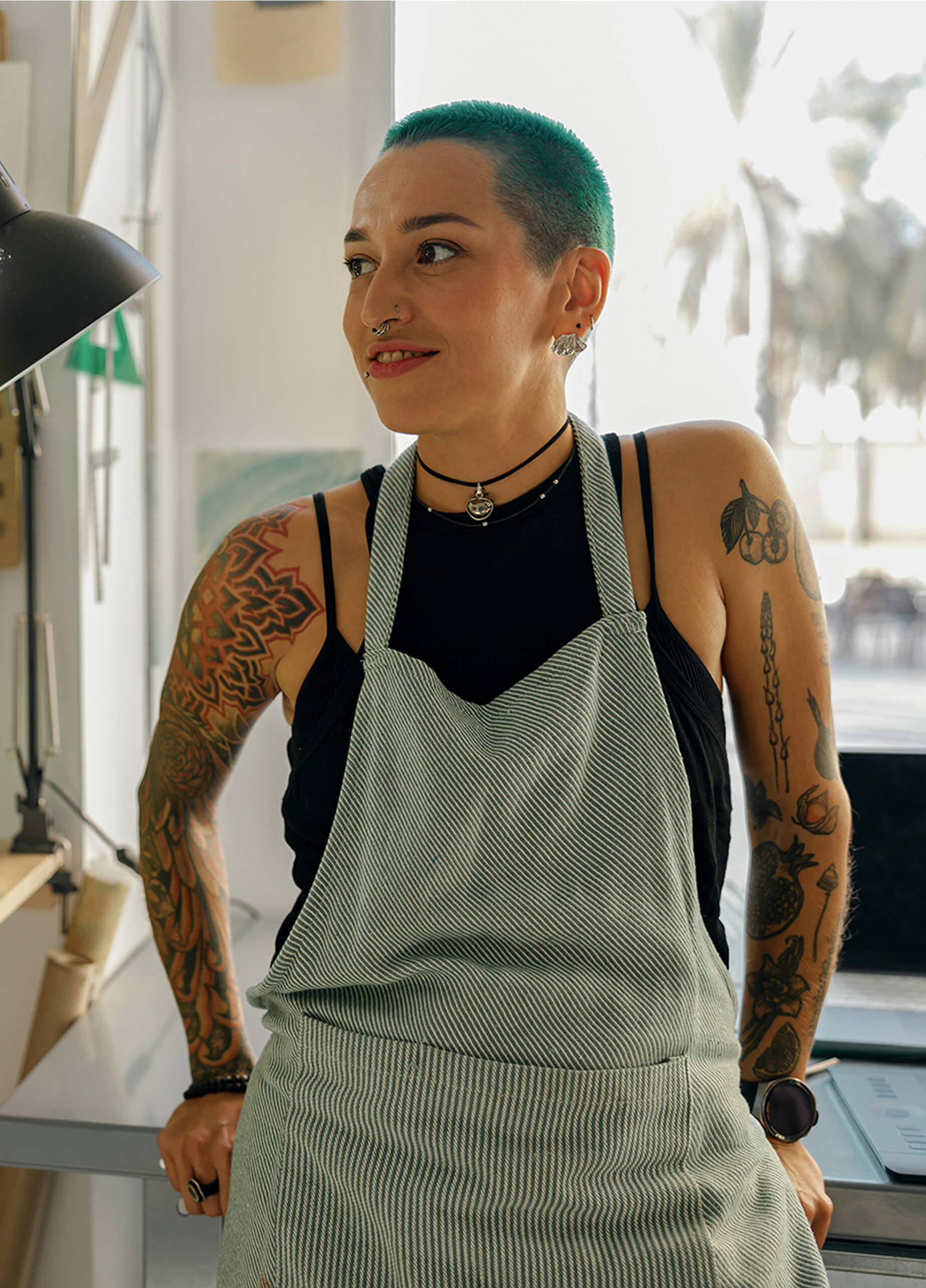 Androgenous presenting person sat at desk