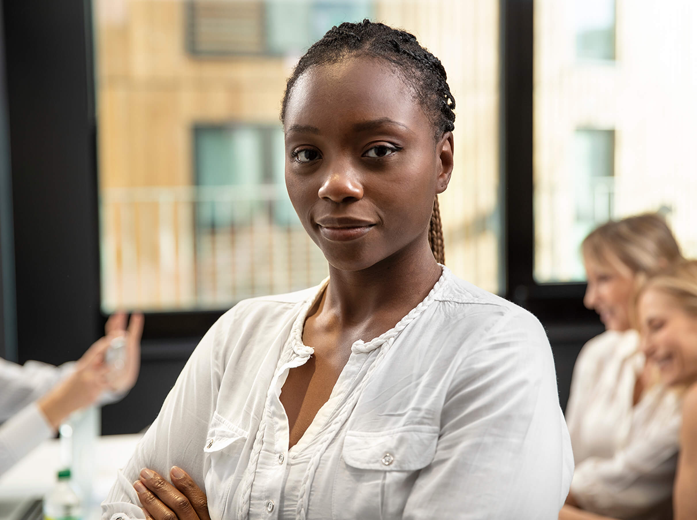 Corporate person crossing arms and looking at camera