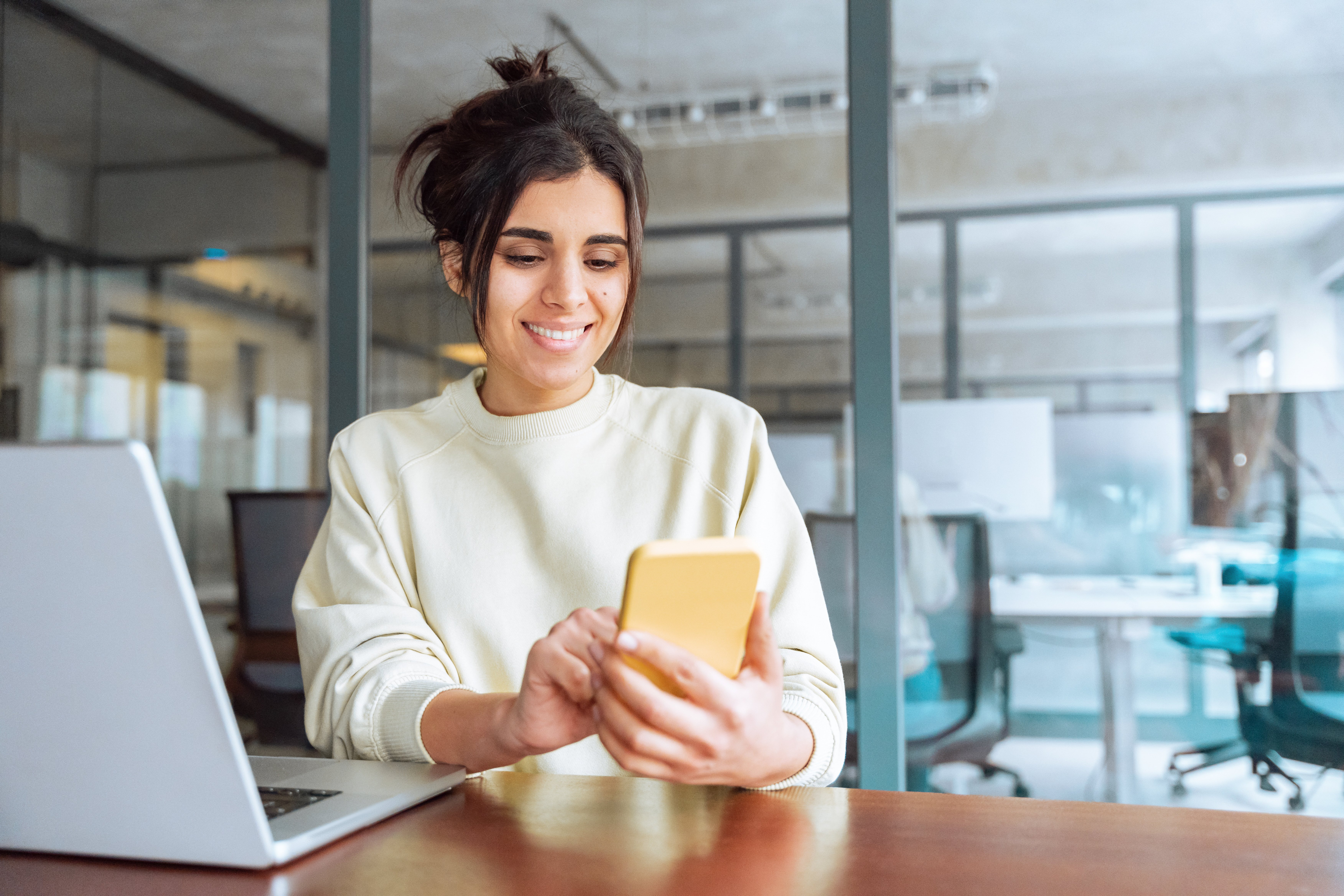 Hispanic business woman manager using cell phone mobile app,
