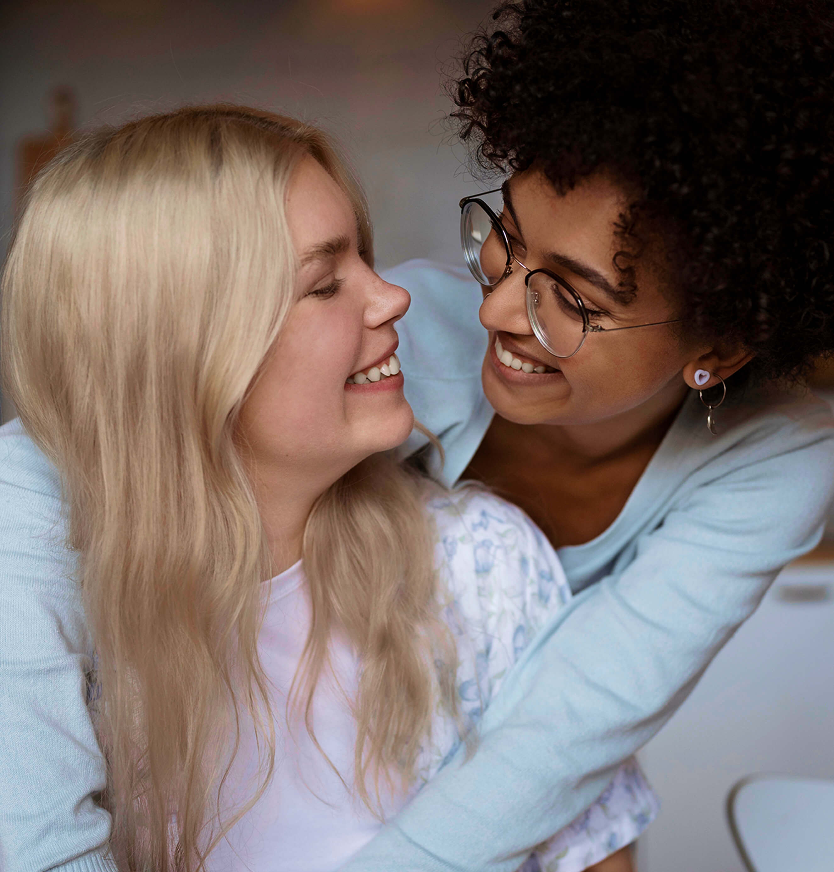 Same sex couple embracing and smiling