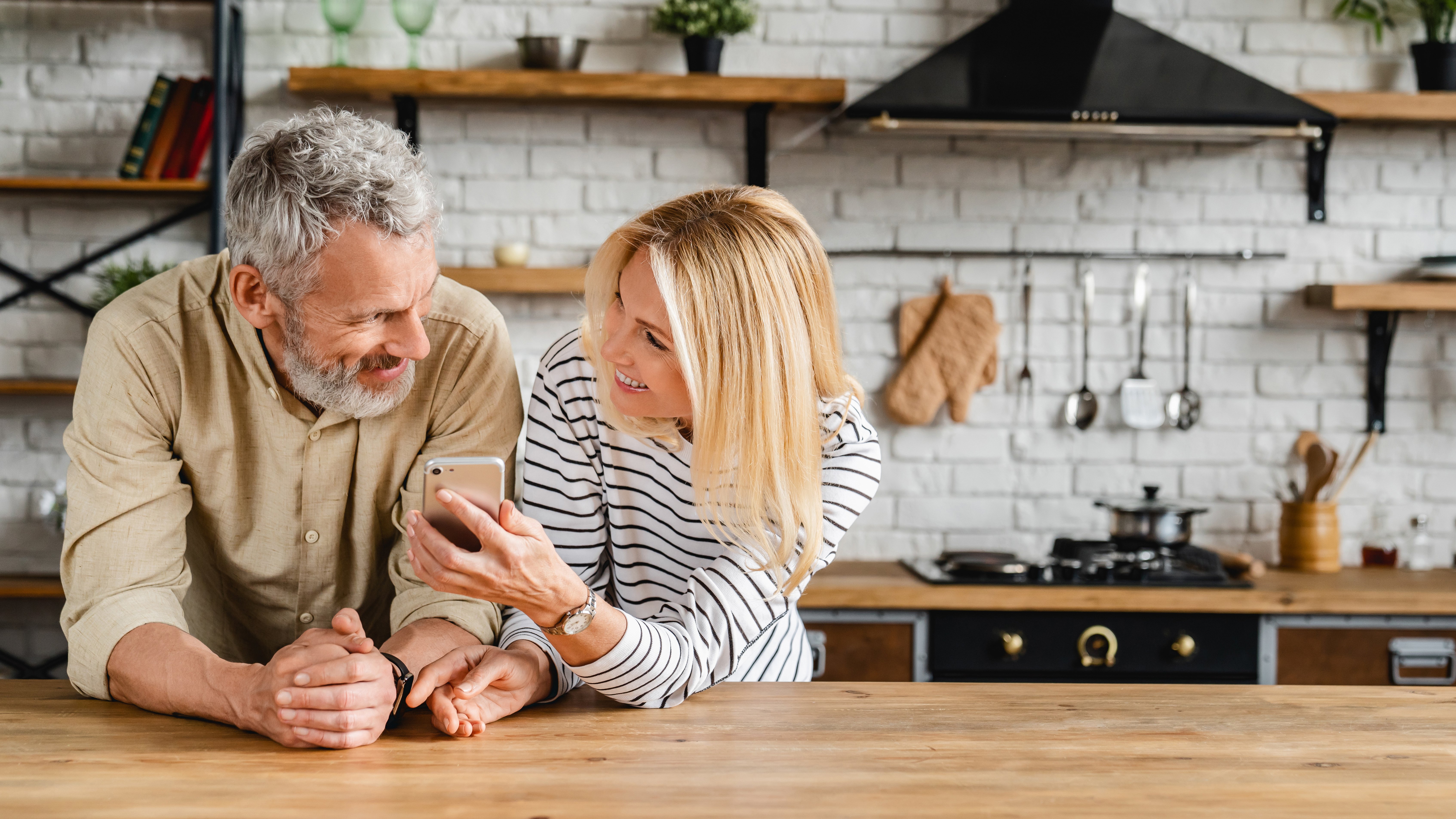 Man and women in the kitchen looking at a smart phone