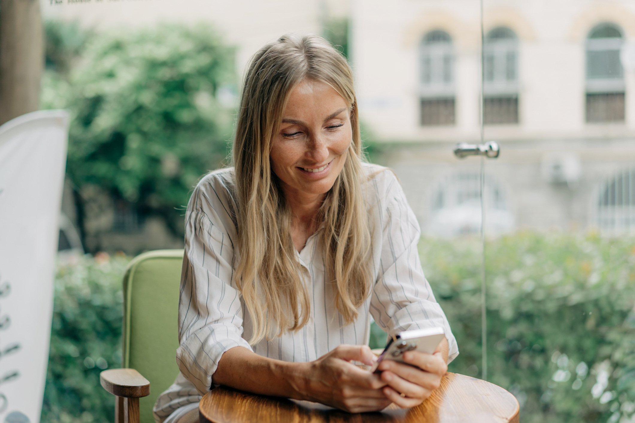 Lady sitting outside on smart phone