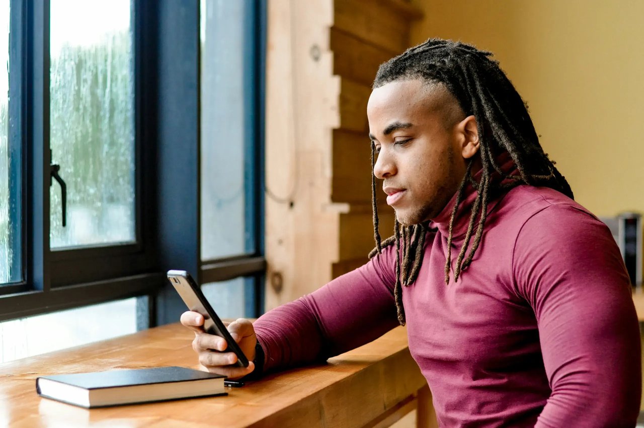 Person relaxing at home while using a mobile phone