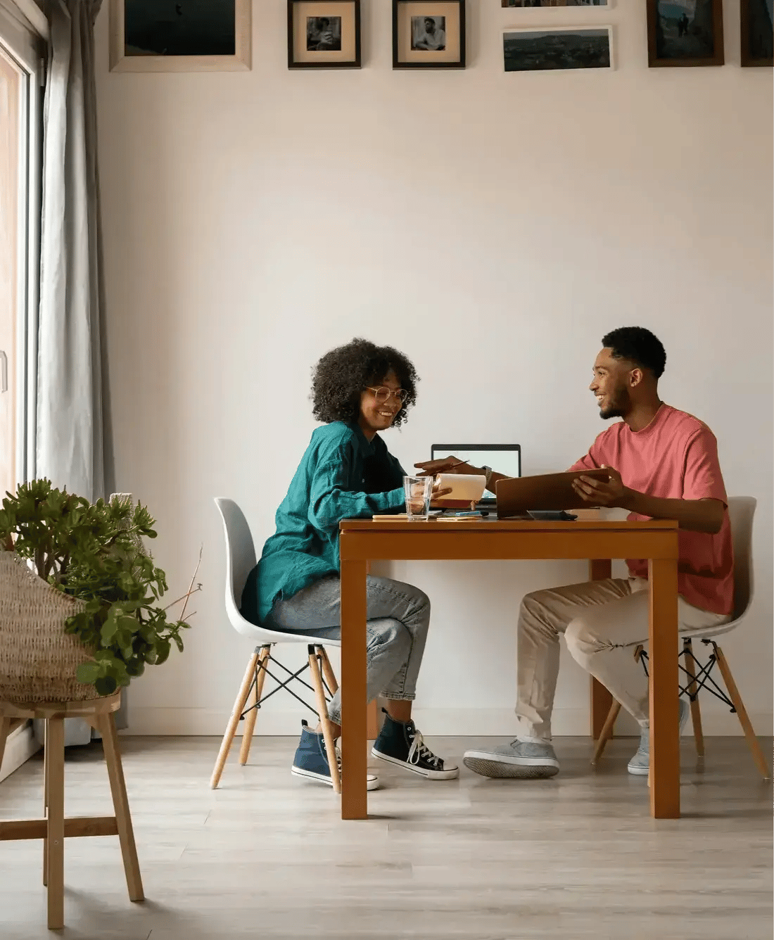 couple sitting at table on laptop