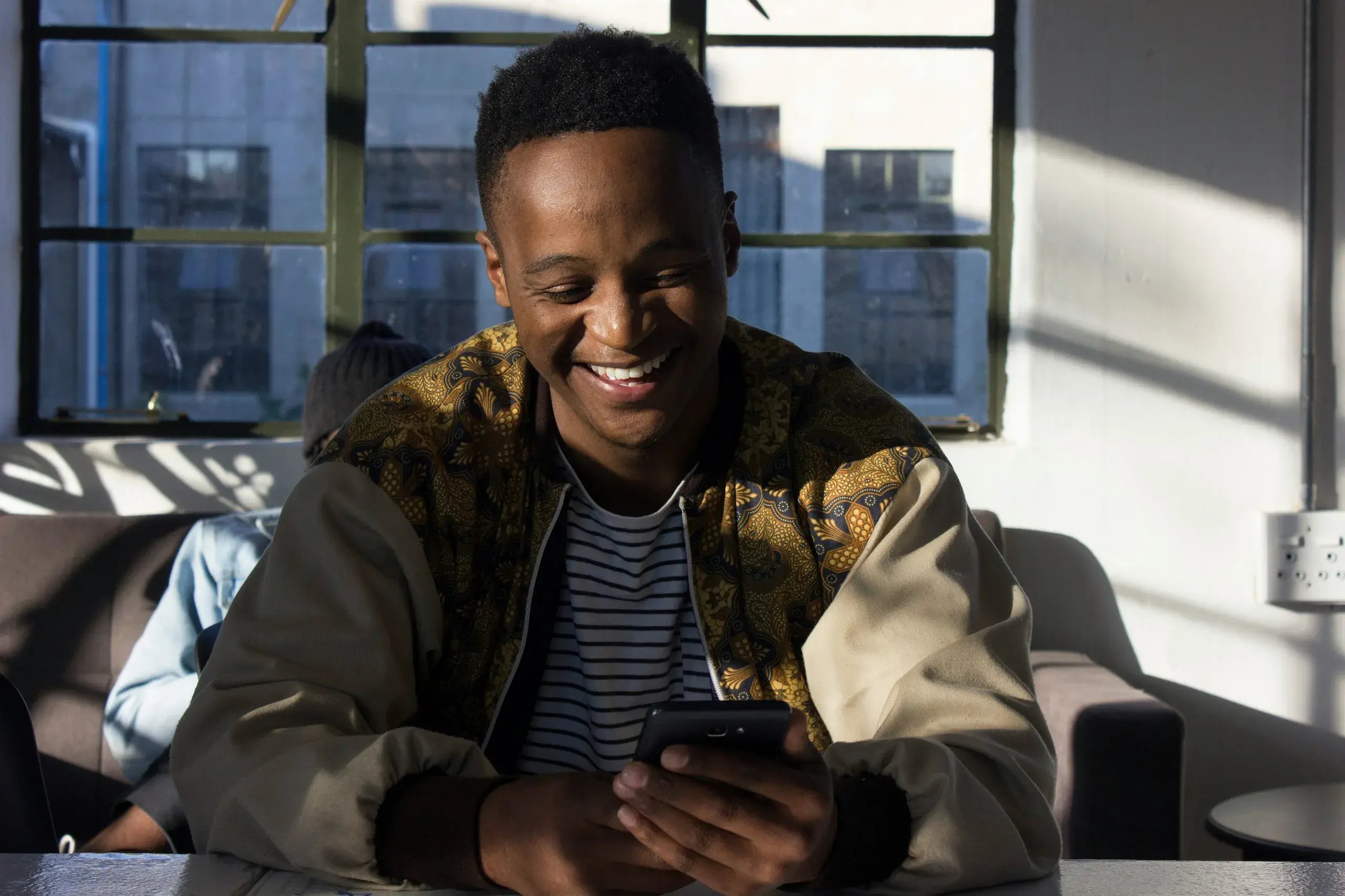 man smiling at phone