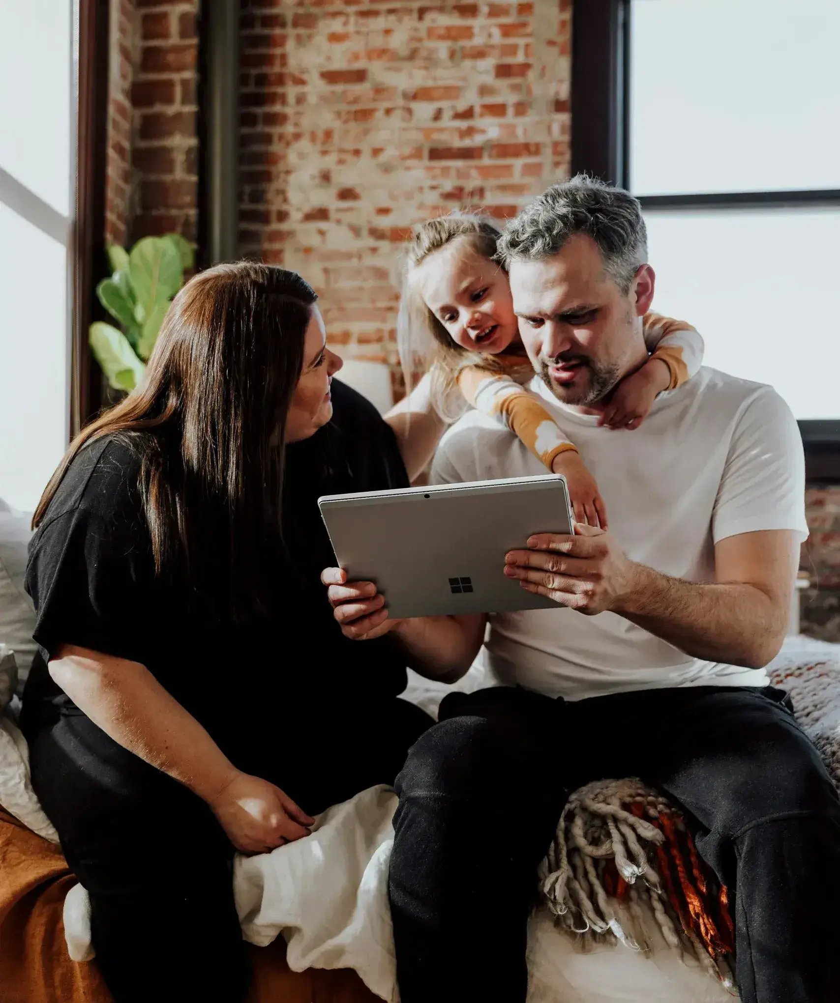 family looking at laptop