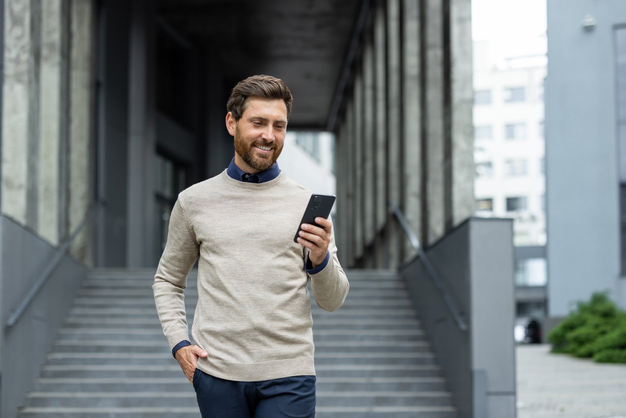 Man outside holding a phone