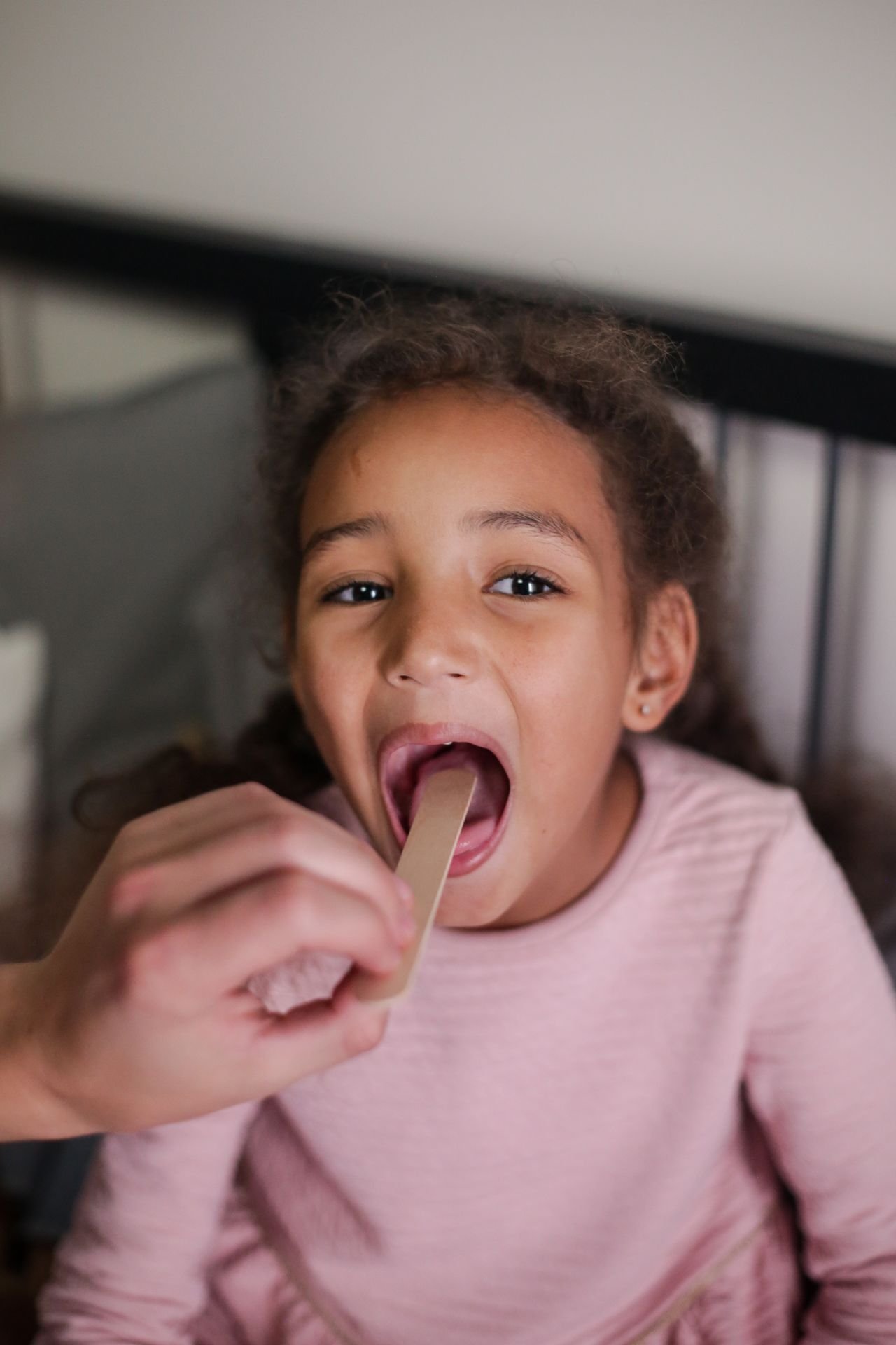 child with tongue stick