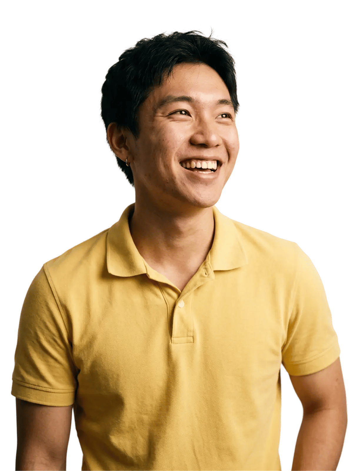 Smiling man in a yellow polo shirt against a soft green background