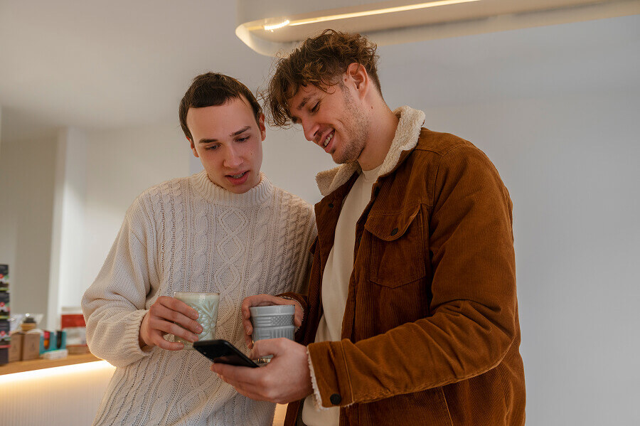 2 men looking at a phone