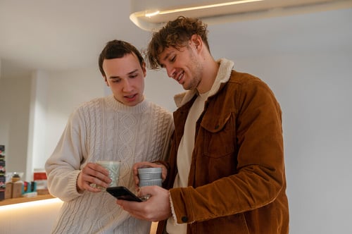2 men looking at a phone