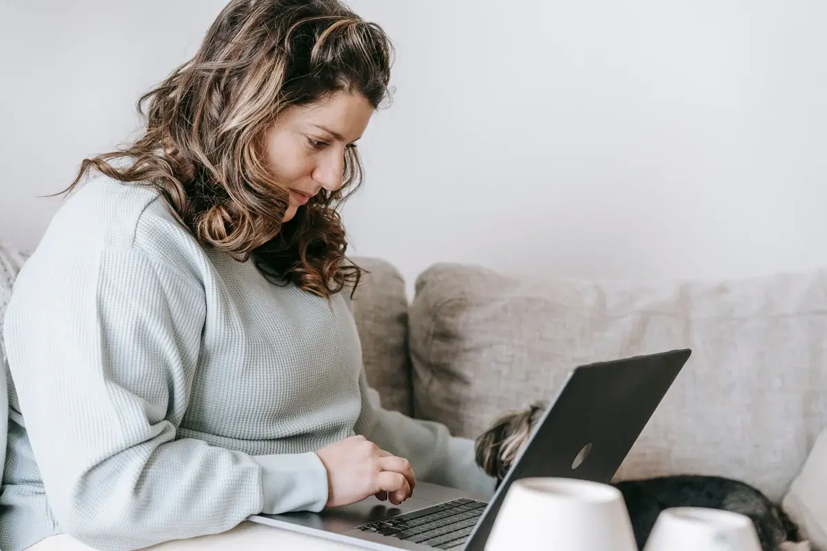overweight woman sat on laptop
